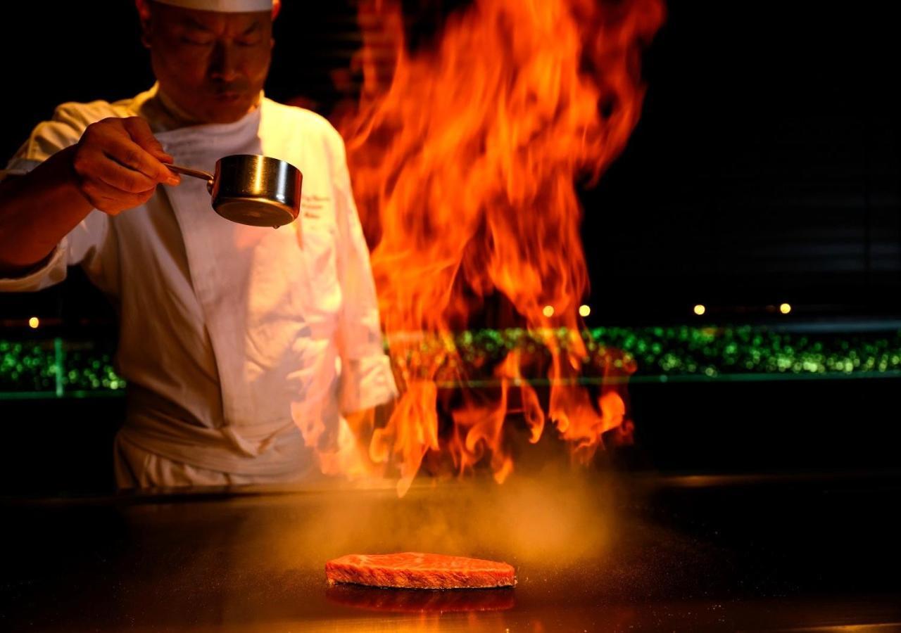 Hotel Monterey Okinawa Spa & Resort Onna Exterior foto A chef cooking with the technique of flambe